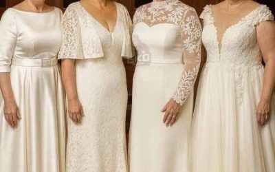Four dresses, one timeless bride: which wedding dress is most suitable for women over 60?  Four dresses, one timeless bride: which one should I choose?  Are wedding dresses still popular after 60? The photo you shared has been circulating for years because it is so striking: four women who look like sisters, or perhaps even the same woman Photoshopped, each in a different white dress, numbered from 1 to 4. The same silver pixie cut, the same smile, the same warm light, but four completely different bridal personalities.  It is not about age, but about architecture. After your 50s or 60s, the right dress depends less on trends than on structure, comfort, and what you want to draw attention to. Below is an analysis of each style, who it is most suitable for, and how to style it for a real wedding, a second wedding, a renewal of vows, or a special occasion such as Mother of the Bride Day.  The common point: all four dresses work because they adhere to three rules for mature brides:  Support comes first: built-in boning or a clearly defined waist, no tight jersey. Strategically exposed skin: coverage where most women want it (upper arms, bust), with a touch of sensuality elsewhere (neckline, back). Matte rather than shiny: satin and lace look better in photos than glittering sequins under the lights of a ballroom. And now for the details.  1 — The classic satin A-line dress. Features: boat neckline, three-quarter sleeves, wide satin belt, and a full A-line skirt of soft ivory satin.  Why it works: It is a garment reminiscent of Grace Kelly. The boat neckline broadens narrow shoulders, the belt creates a waist without the need for a corset, and the three-quarter sleeve is the most universal way to cover the arms, as it reaches to the narrowest part of the forearm.Ideal for: people with an apple-shaped or rectangular figure, and anyone who wants to hide their tummy. The satin texture glides smoothly over the skin without sticking.  Warning: Every small tear is visible in the satin. Choose one size larger and have the dress altered by a seamstress. Opt for a low block heel; the hem is long.  Style example: Pearl earrings (like she is wearing), a low bun, no necklace, the neckline speaks for itself.  2 — The romantic lace sheath dress with ruffled sleeves Description: entirely made of stretchy lace, deep V-neck, soft ruffled sleeves to the elbow, sheath dress style that flares out slightly at the hem.  Why it works: The V-neckline opens up the décolleté and lengthens the neck, while the ruffles add movement without feeling too heavy. The lace is comfortable and does not wrinkle, even after a long day.  Ideal for: women with an hourglass or pear figure who want to accentuate their curves without feeling restricted. The vertical lace pattern creates a slimmer look.  Please note: Deep V-necklines require proper underwear. A balconette or push-up bra is essential. If you feel uncomfortable with your upper arms, ensure the ruffles cover only the top part, not the entire arm.  Style: Soft waves (even short hair can get texture), a subtle pendant at the V-neck, nude or light pink shoes.  3 — The modern dress with illusion effect and high neckline. Description: Long, sheer lace sleeves, illusion effect with a high neckline, sweetheart-shaped satin bodice, and a smooth satin skirt with a narrow belt.  Why it works: It is the most fashionable and supportive style. The illusion effect fully covers the arms and bust, while still maintaining a light, bridal look. The sweetheart neckline underneath lifts, while the sheer overlay provides discreet coverage.  Ideal for: women with a full bust, broad shoulders, or anyone who wants sufficient coverage without looking too old-fashioned. Also perfect for religious ceremonies or winter weddings.  Please note: high collars can feel warm. Choose a breathable fabric.ce (Chantilly, not heavily embellished with beads). Make sure the illusion matches your skin tone.  Here’s how to do it: Gather your hair to accentuate your neckline, wear striking earrings and no necklace. A low, elegant bun gives the look a modern touch.  4 — The soft, off-the-shoulder A-line dress. Description: Off-the-shoulder lace straps, deep V-neck, bodice with appliqués, and a flowy tulle A-line skirt.  Why it works: The off-the-shoulder neckline draws the eye horizontally and balances the hips. The deep V-neck is softened by the lace trim, resulting in a sensual yet understated look. The tulle drapes elegantly and conceals the legs.  Ideal for: women with a pear figure, petite brides who want to make their figure look slimmer (the V-neck), and anyone who loves a beautiful skirt without the weight of satin.